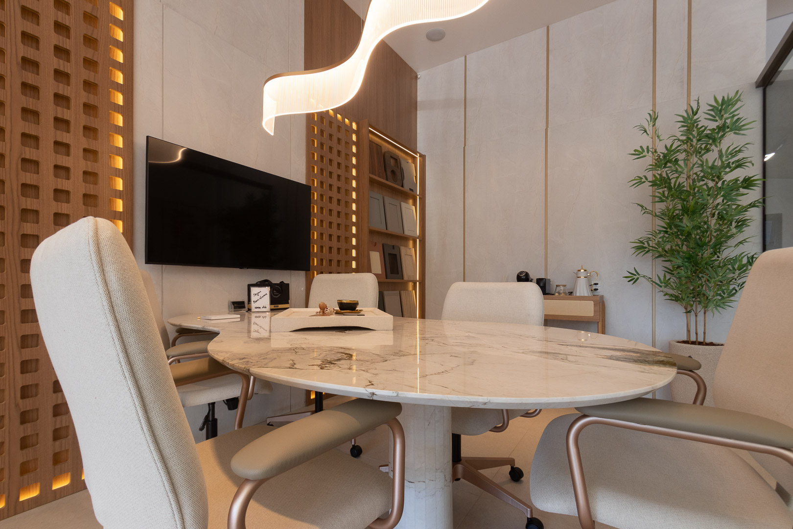 Sala de reuniões com TV e mesa oval